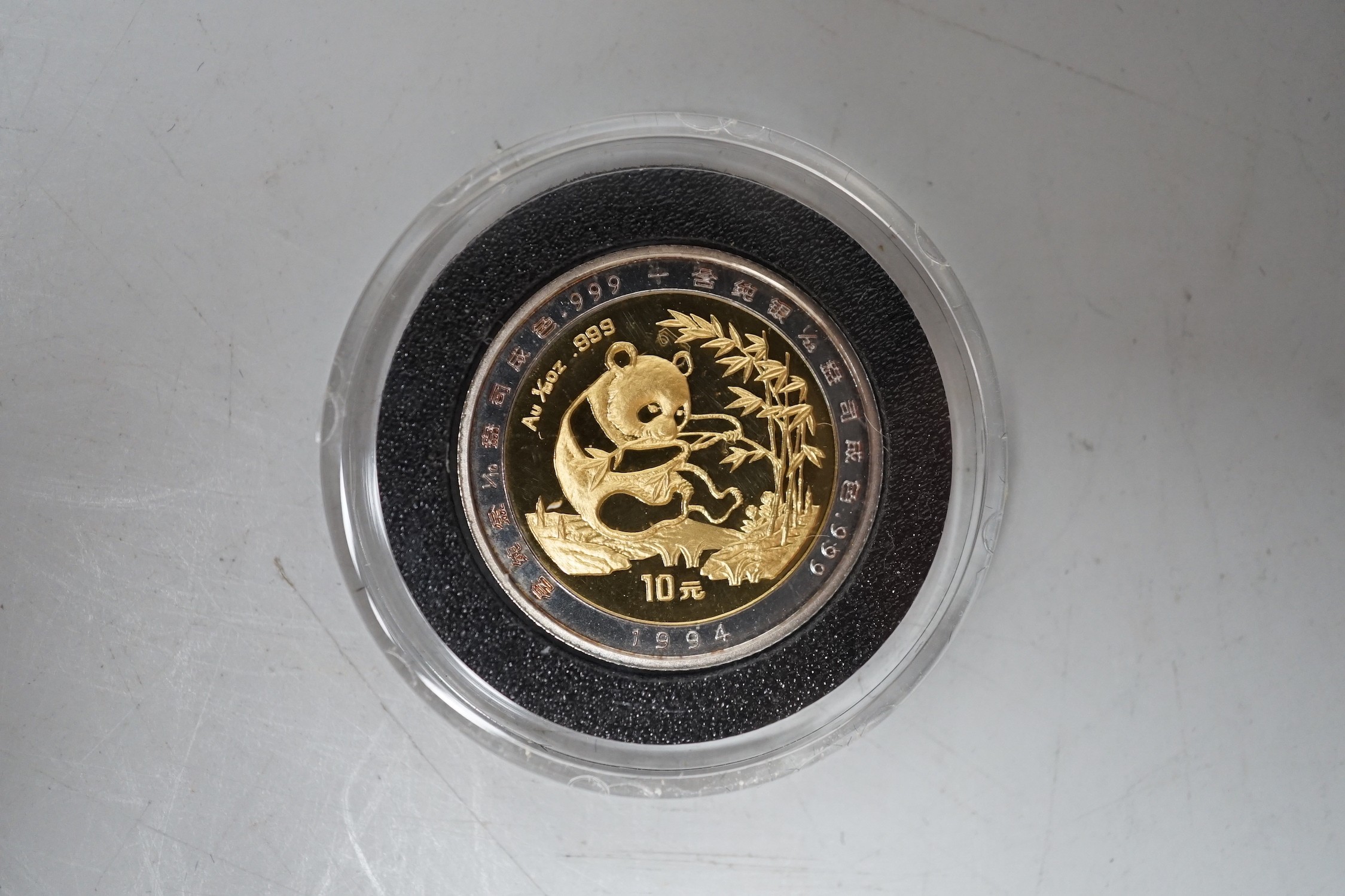 A Chinese Panda gold and silver 10 Yuan coin